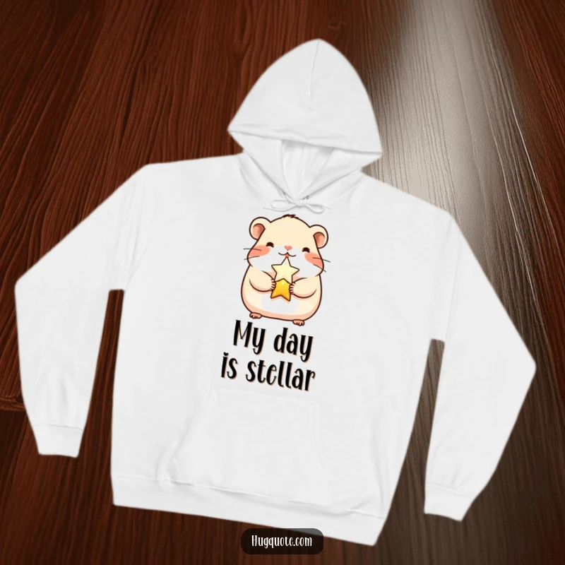 Funny cheerful hamster character embracing a shining star on a soft hoodie, offering cozy comfort and cute charm.