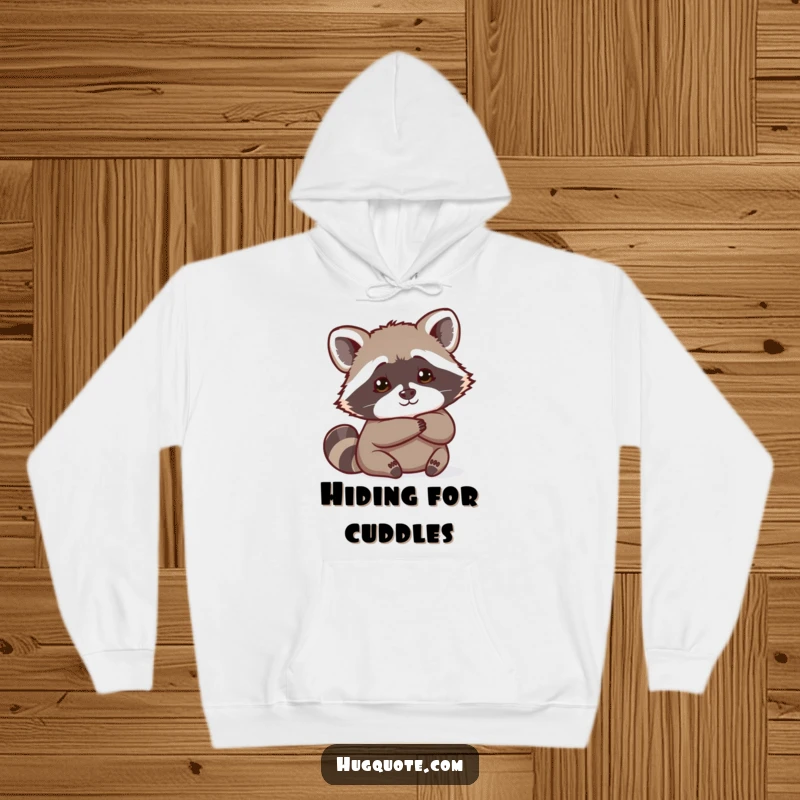 Funny Raccoon Hoodie showing a curious raccoon peeking from behind a hug, offering warmth and playful mystery.